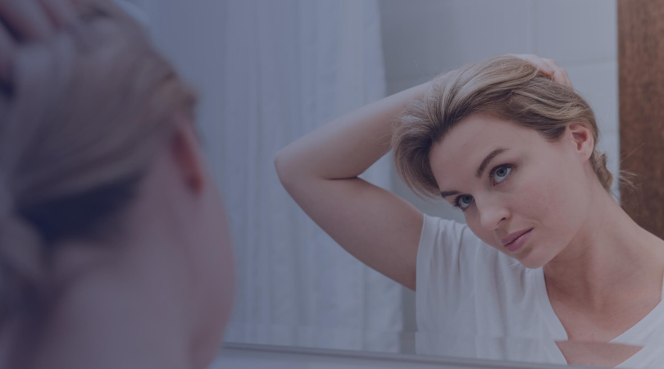 A woman with full, healthy, voluminous hair in golden-hour light