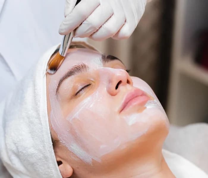 Esthetician performing a MicroPeel exfoliating facial treatment