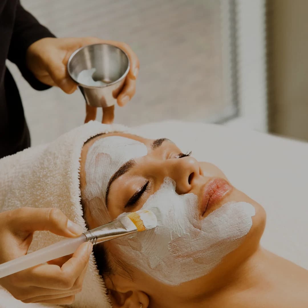 Esthetician applying a customized facial treatment to a client's skin
