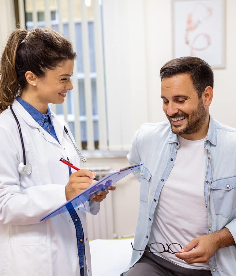 A provider reviewing treatment safety with a male patient