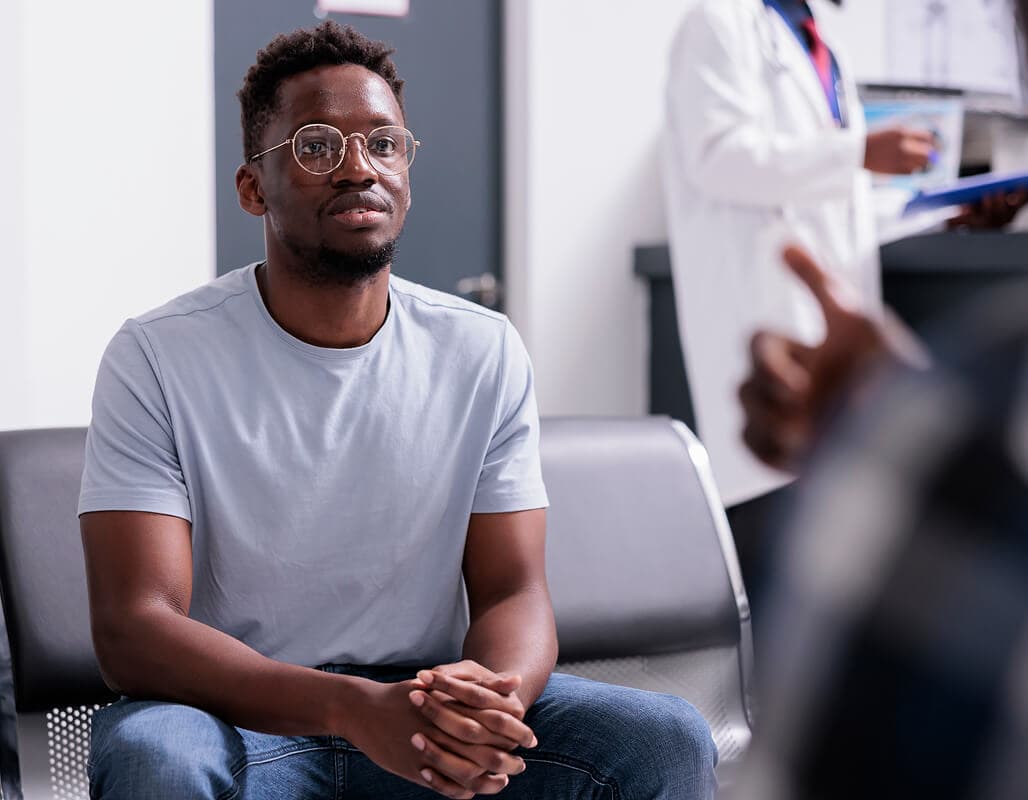 A patient reviewing symptoms and labs with a provider